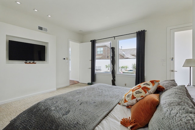 bedroom featuring visible vents, baseboards, and carpet