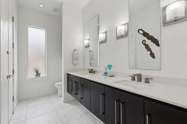 full bath with toilet, visible vents, marble finish floor, and a sink