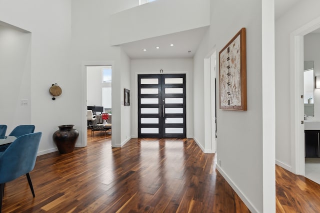 entrance foyer with baseboards and hardwood / wood-style flooring