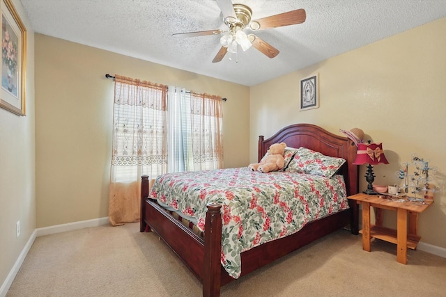 bedroom featuring ceiling fan, carpet flooring, baseboards, and a textured ceiling