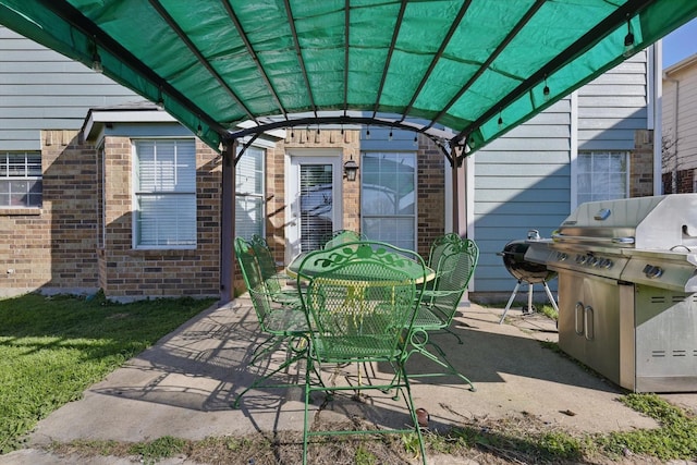 view of patio / terrace featuring outdoor dining space and grilling area