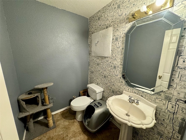 469 Streetman Rd, Royse City, TX 75189 - half bath with tile patterned flooring, baseboards, toilet, a textured ceiling, and a sink