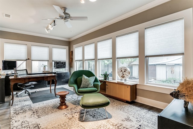 office area with light wood finished floors, visible vents, a healthy amount of sunlight, and crown molding