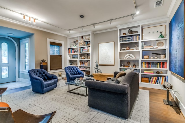 sitting room featuring visible vents, arched walkways, and track lighting