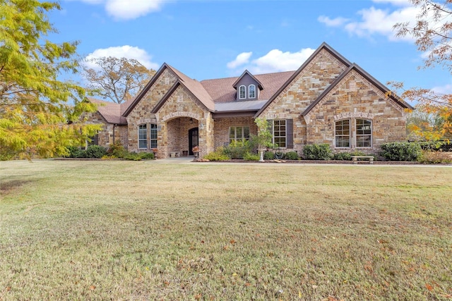 french country style house with a front lawn