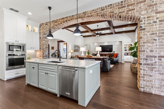 kitchen with visible vents, appliances with stainless steel finishes, arched walkways, coffered ceiling, and a sink