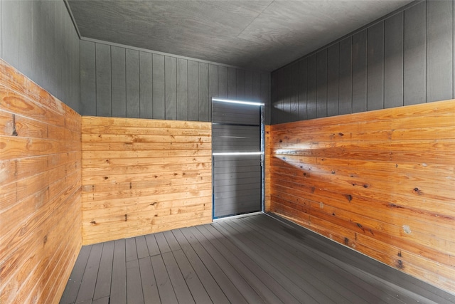 interior space featuring wooden walls and hardwood / wood-style floors