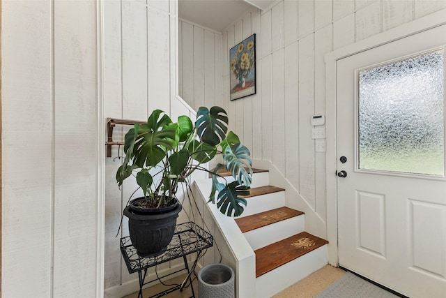 entryway with wooden walls