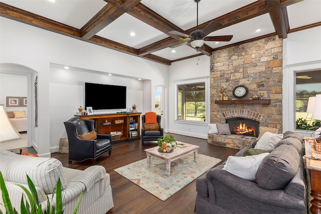 living room featuring beam ceiling, dark wood finished floors, a fireplace, and coffered ceiling