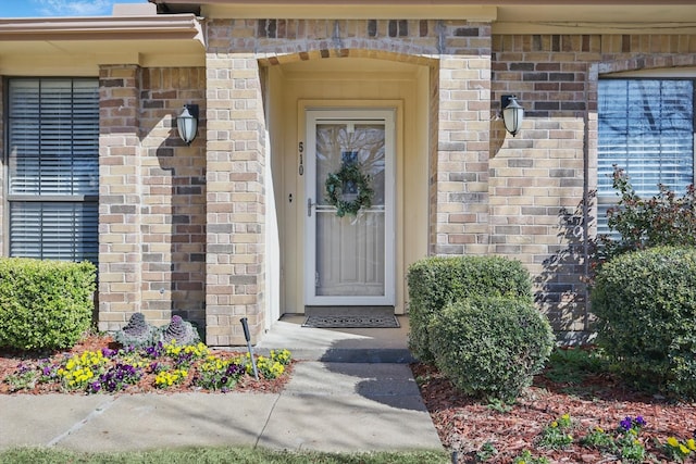 entrance to property with brick siding