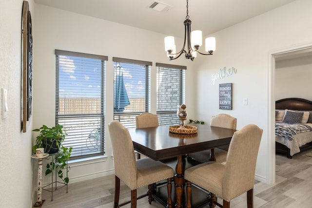 dining space with baseboards, a healthy amount of sunlight, visible vents, and light wood-type flooring