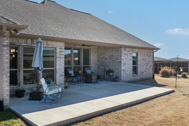 view of patio / terrace with a ceiling fan and fence