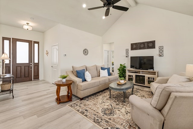 living room with light wood-type flooring, high vaulted ceiling, beamed ceiling, and a ceiling fan