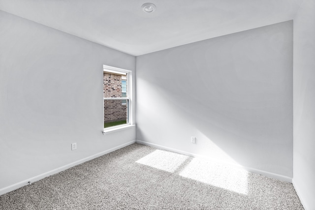 carpeted spare room with baseboards