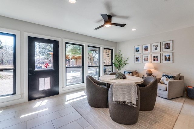 tiled dining space featuring recessed lighting and a ceiling fan