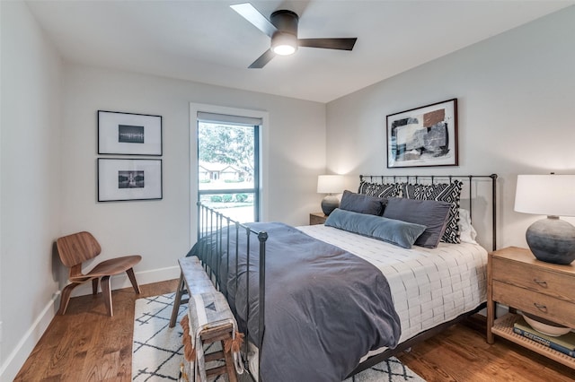 bedroom featuring access to exterior, wood finished floors, baseboards, and ceiling fan