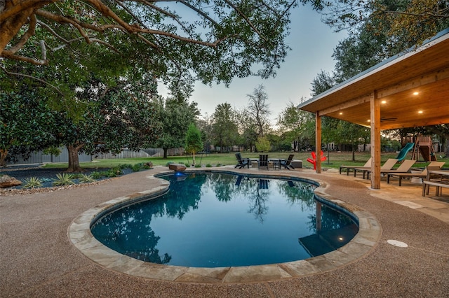 view of swimming pool with a fenced in pool, a patio area, and fence