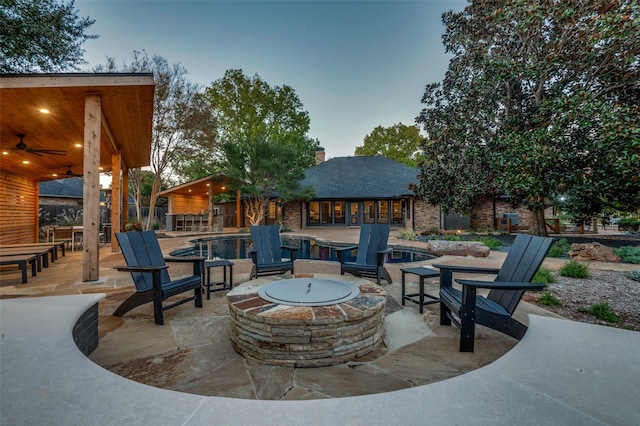 view of patio / terrace featuring ceiling fan and an outdoor fire pit