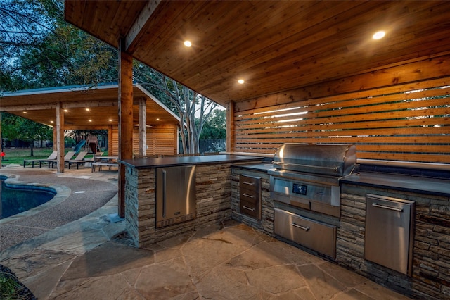 view of patio / terrace featuring area for grilling and exterior kitchen