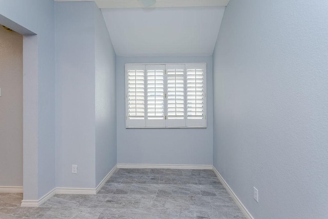 spare room with baseboards