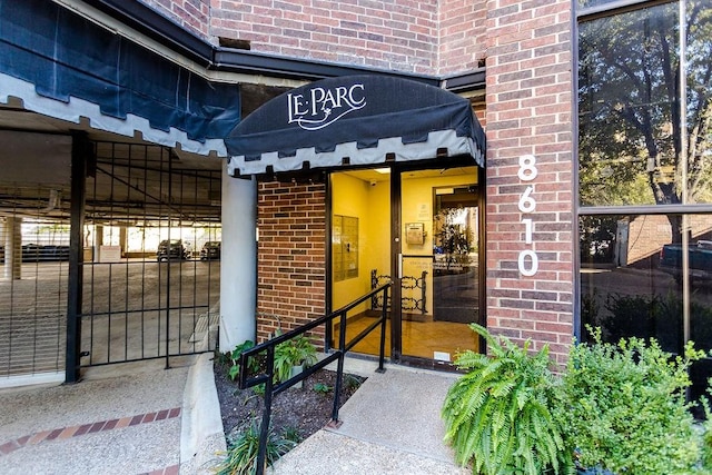 doorway to property featuring brick siding