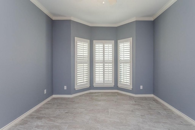 unfurnished room with baseboards and ornamental molding