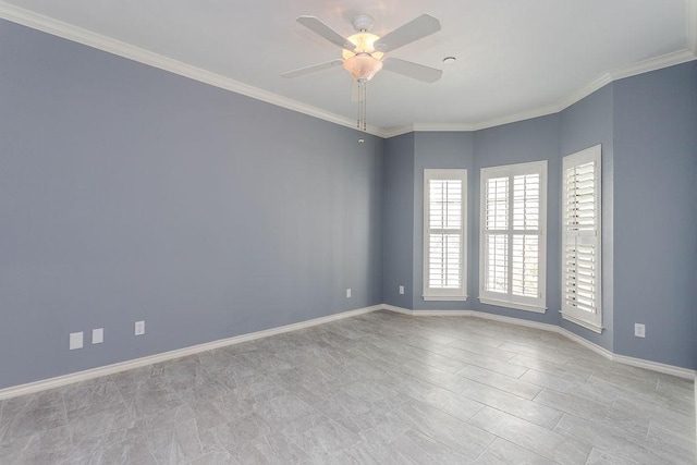 empty room featuring a ceiling fan, baseboards, and ornamental molding