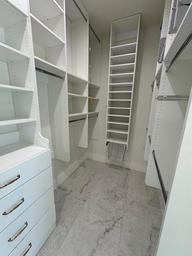 spacious closet with marble finish floor