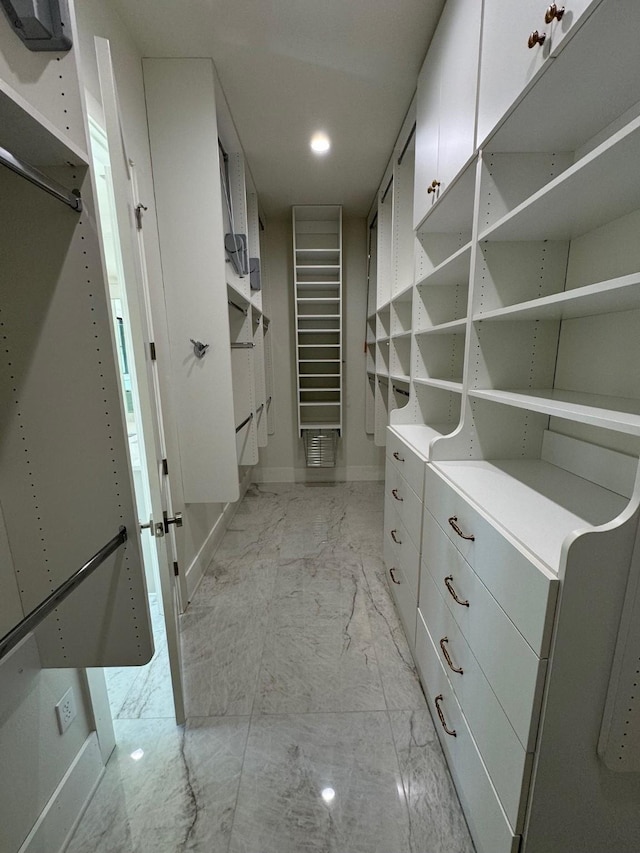 spacious closet featuring marble finish floor