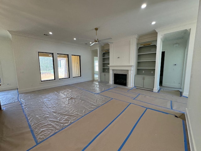 unfurnished living room featuring recessed lighting, baseboards, and built in shelves