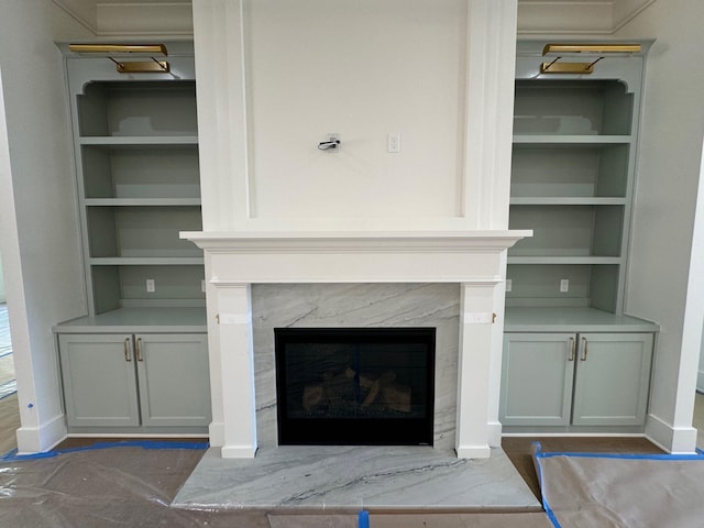 room details featuring built in shelves and a fireplace