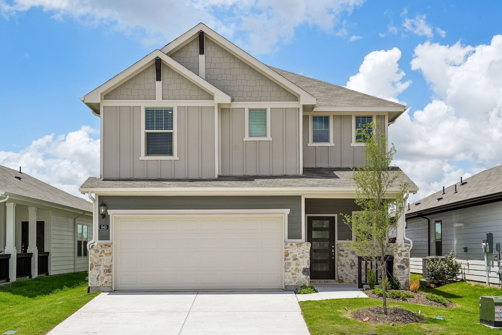 945 Summer Dr, Lavon, TX 75166 - craftsman-style house with board and batten siding, concrete driveway, a garage, and stone siding