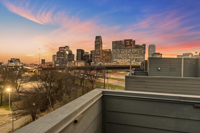 balcony at dusk with a view of city