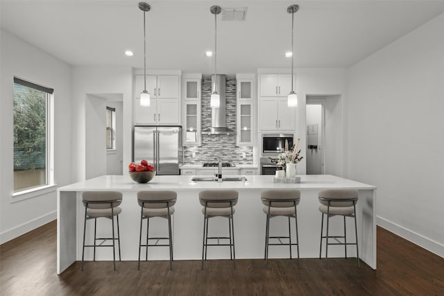 3012 Zenia Dr, Dallas, TX 75204 - kitchen with stainless steel appliances, wall chimney exhaust hood, tasteful backsplash, a large island, and white cabinets