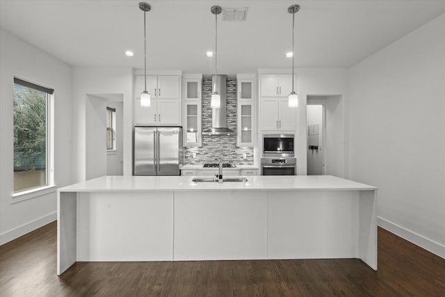 kitchen with white cabinetry, wall chimney exhaust hood, backsplash, and stainless steel appliances