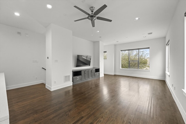 unfurnished living room featuring dark wood-style floors, recessed lighting, and visible vents