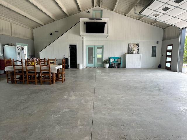 garage with french doors, metal wall, and white fridge with ice dispenser