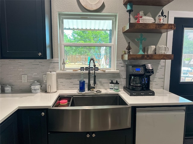 kitchen featuring open shelves, dishwasher, light countertops, and a sink