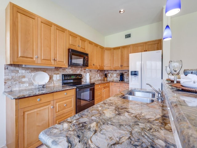 kitchen with visible vents, black appliances, a sink, backsplash, and light stone countertops