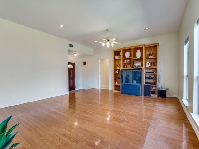 unfurnished living room featuring visible vents, light wood-style flooring, a ceiling fan, recessed lighting, and baseboards