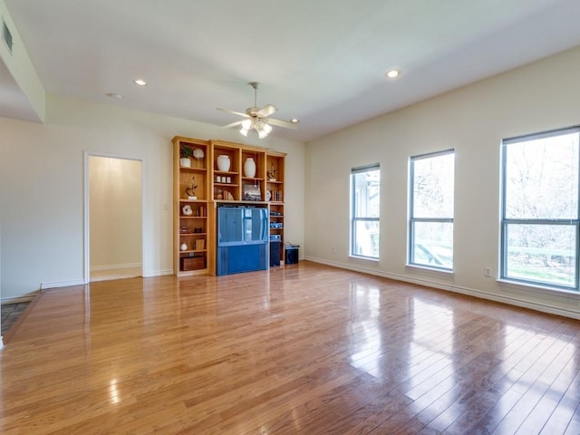 unfurnished living room with visible vents, baseboards, ceiling fan, recessed lighting, and light wood-style flooring