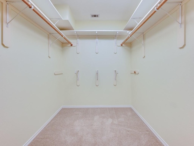 walk in closet featuring visible vents and carpet floors