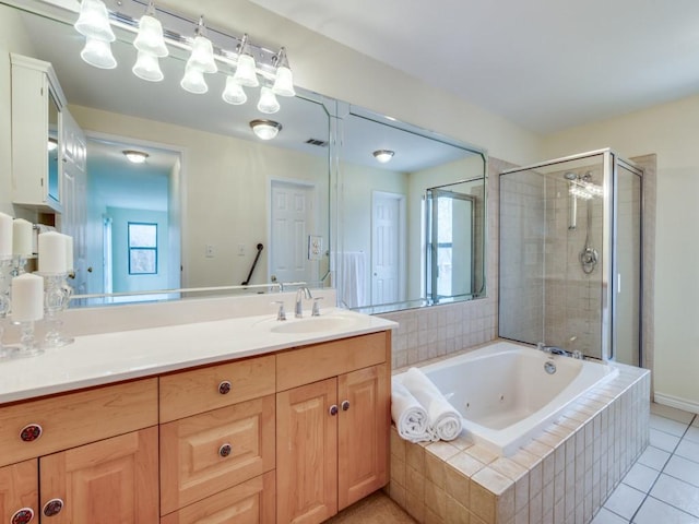 full bathroom featuring vanity, a shower stall, a jetted tub, and plenty of natural light