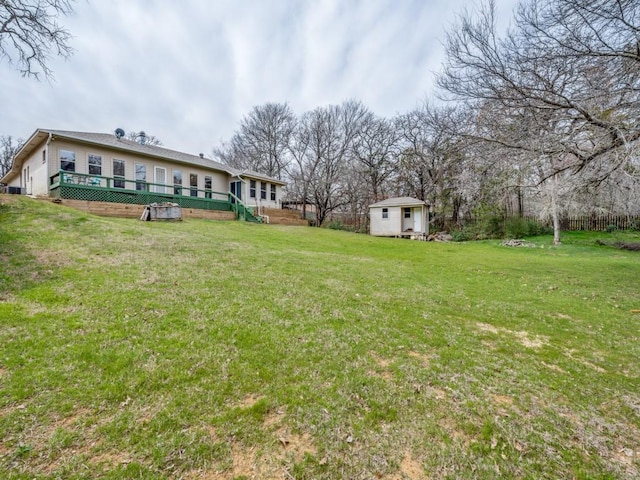 view of yard with a wooden deck and an outbuilding