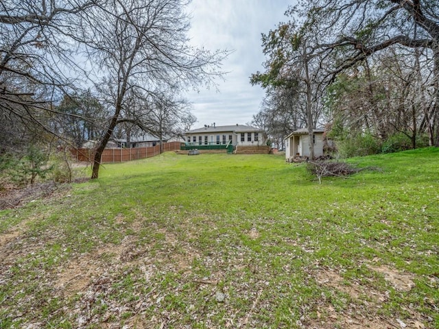 view of yard featuring an outbuilding and fence