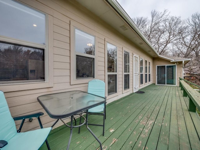 wooden terrace with outdoor dining area