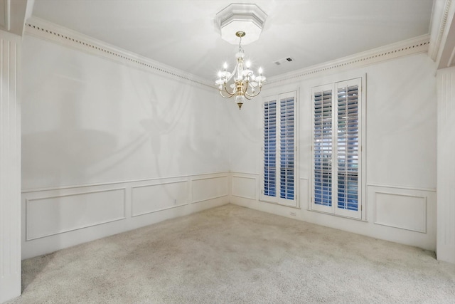empty room featuring visible vents, an inviting chandelier, carpet, and a decorative wall