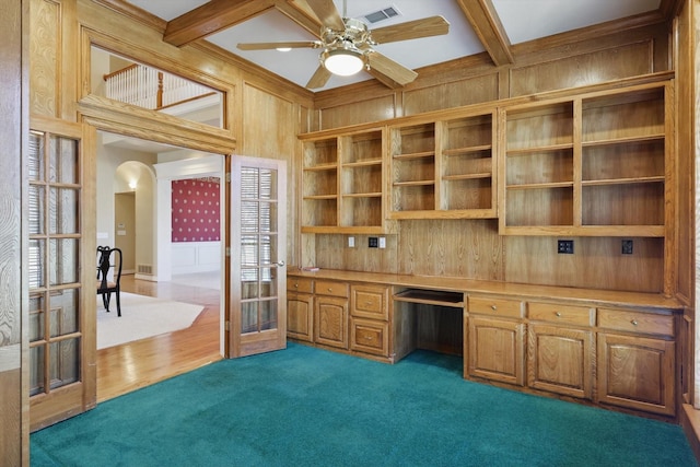 unfurnished office with wooden walls, built in desk, french doors, a ceiling fan, and visible vents