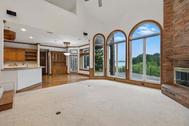 unfurnished living room with ceiling fan, a fireplace, carpet flooring, and recessed lighting