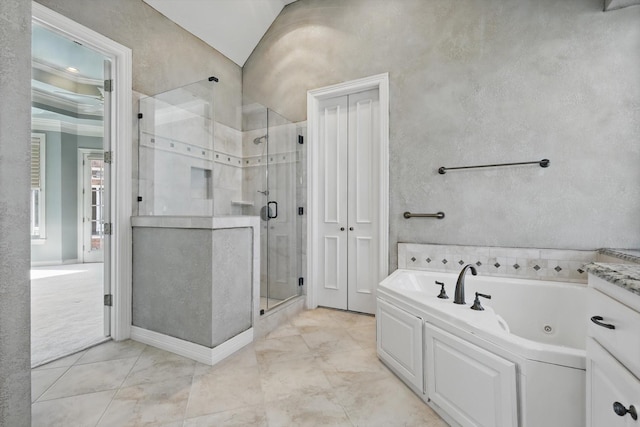 bathroom with a textured wall, a tub with jets, and a shower stall